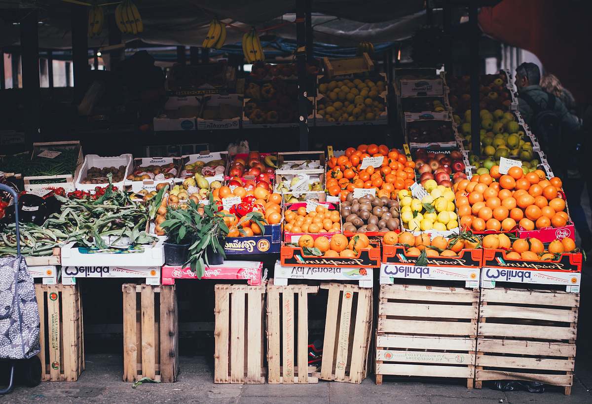 fruit box of fruits on stand beside stall plant